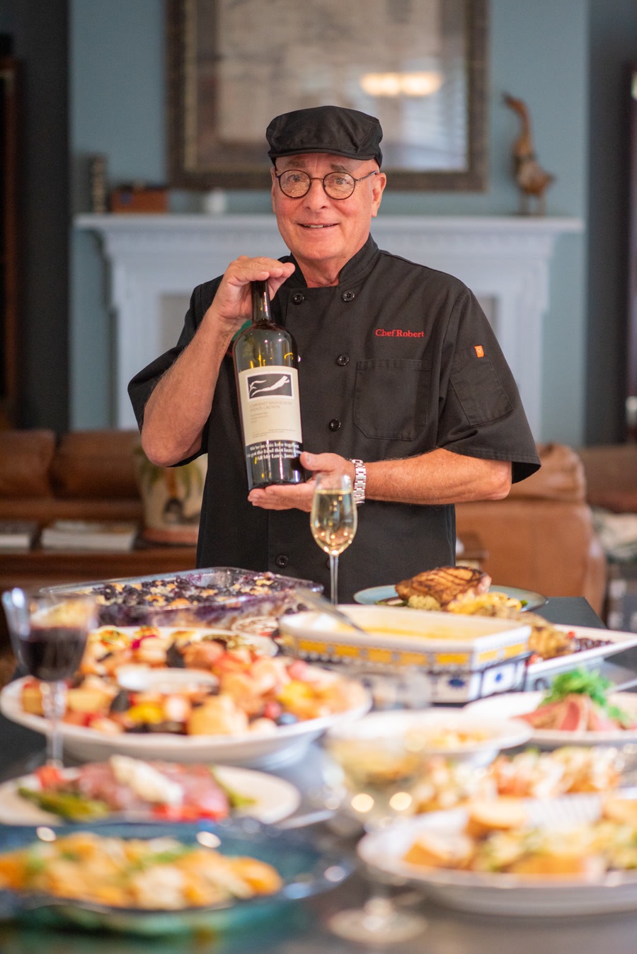 Chef Robert Atchison holding a bottle of wine
