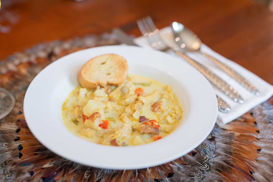 Redfish chowder with potatoes and vegetables, served with toasted bruschetta