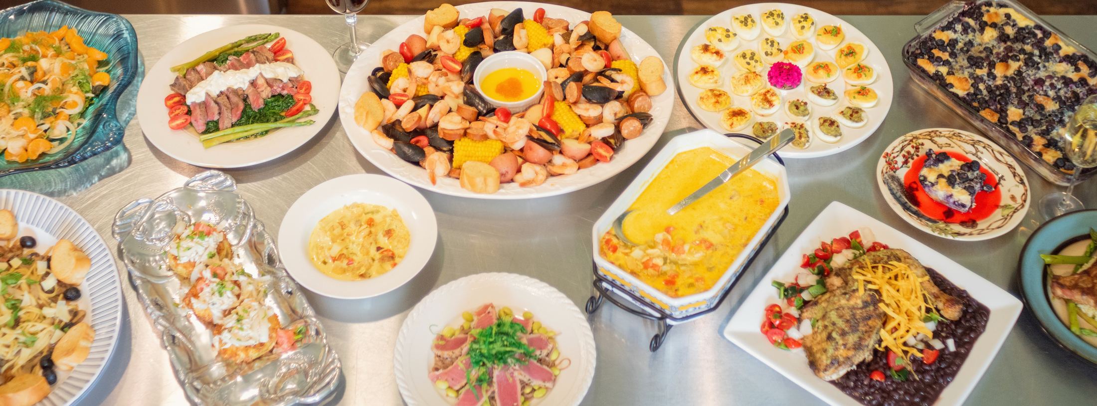 A spread of Horse and Hound catered dishes laid out on a stainless steel table